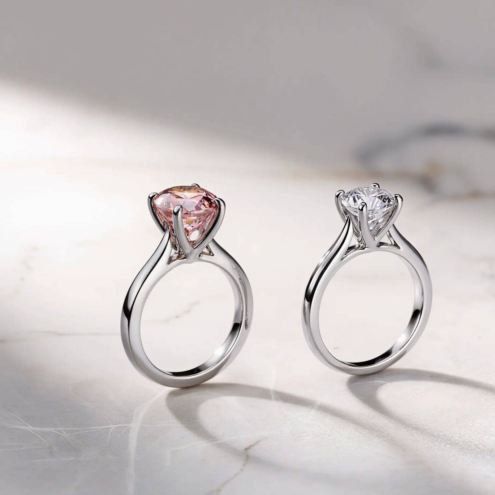Two elegant engagement rings featured in image_71b7ef.jpg: a vibrant pink morganite ring and a colorless diamond ring, illustrating the choice between romantic hues and timeless brilliance.