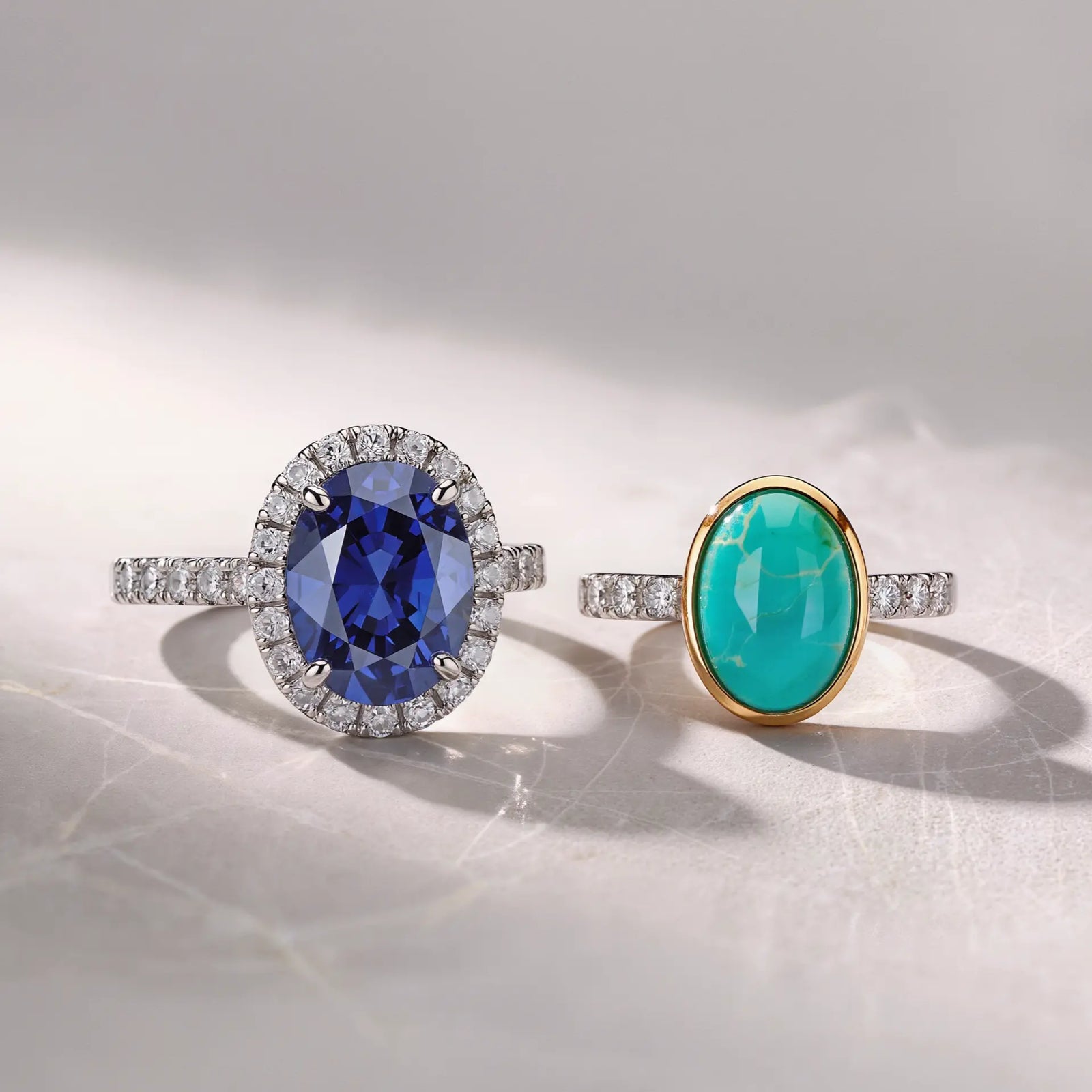 Two unique blue gemstone engagement rings featured in image_ff83c1.jpg: a brilliant oval sapphire ring and a smooth cabochon turquoise ring showcased in a luxury jewelry setting.