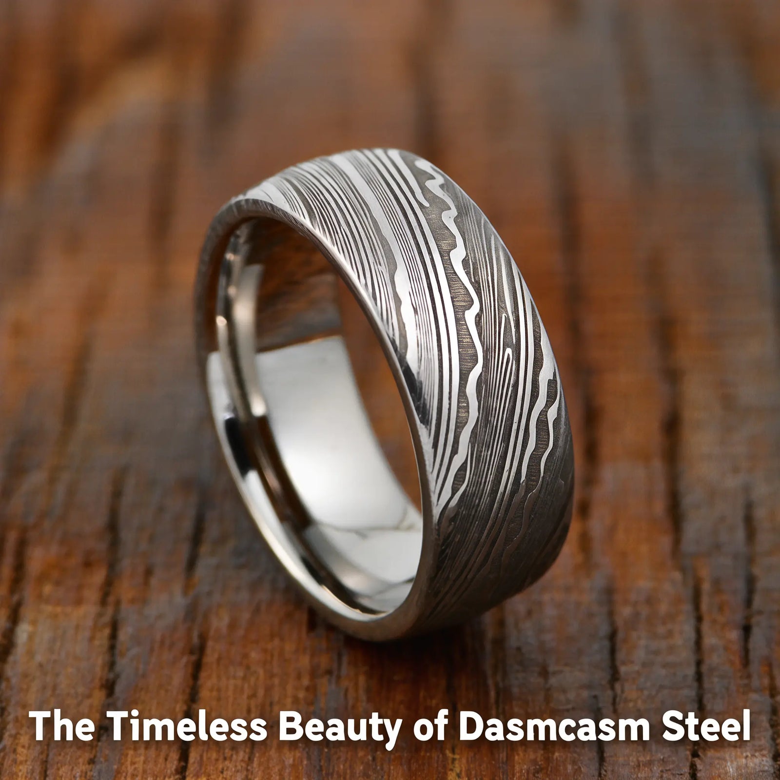 Damascus steel ring with unique wavy patterns on a wooden background