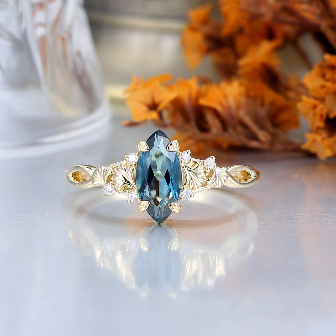 Fijne verlovingsring met London Blue Topaz en ginkgoblad, bruids- en jubileumring