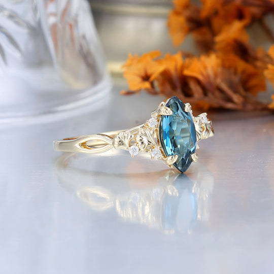 Fijne verlovingsring met London Blue Topaz en ginkgoblad, bruids- en jubileumring