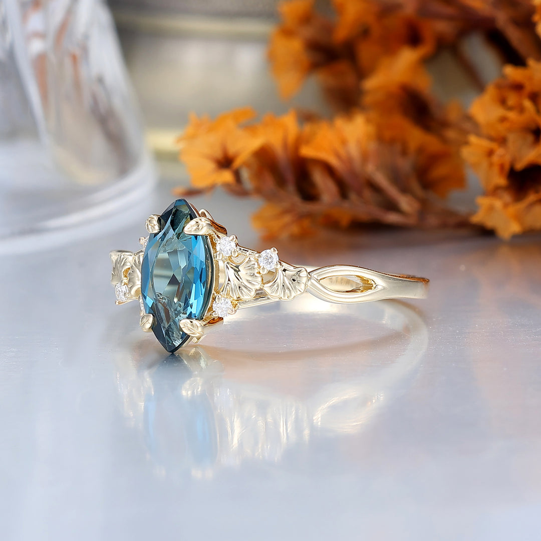 Fijne verlovingsring met London Blue Topaz en ginkgoblad, bruids- en jubileumring