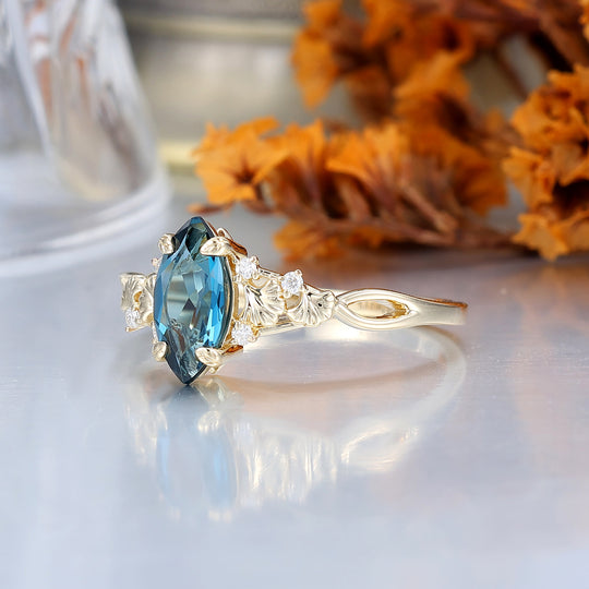Fijne verlovingsring met London Blue Topaz en ginkgoblad, bruids- en jubileumring